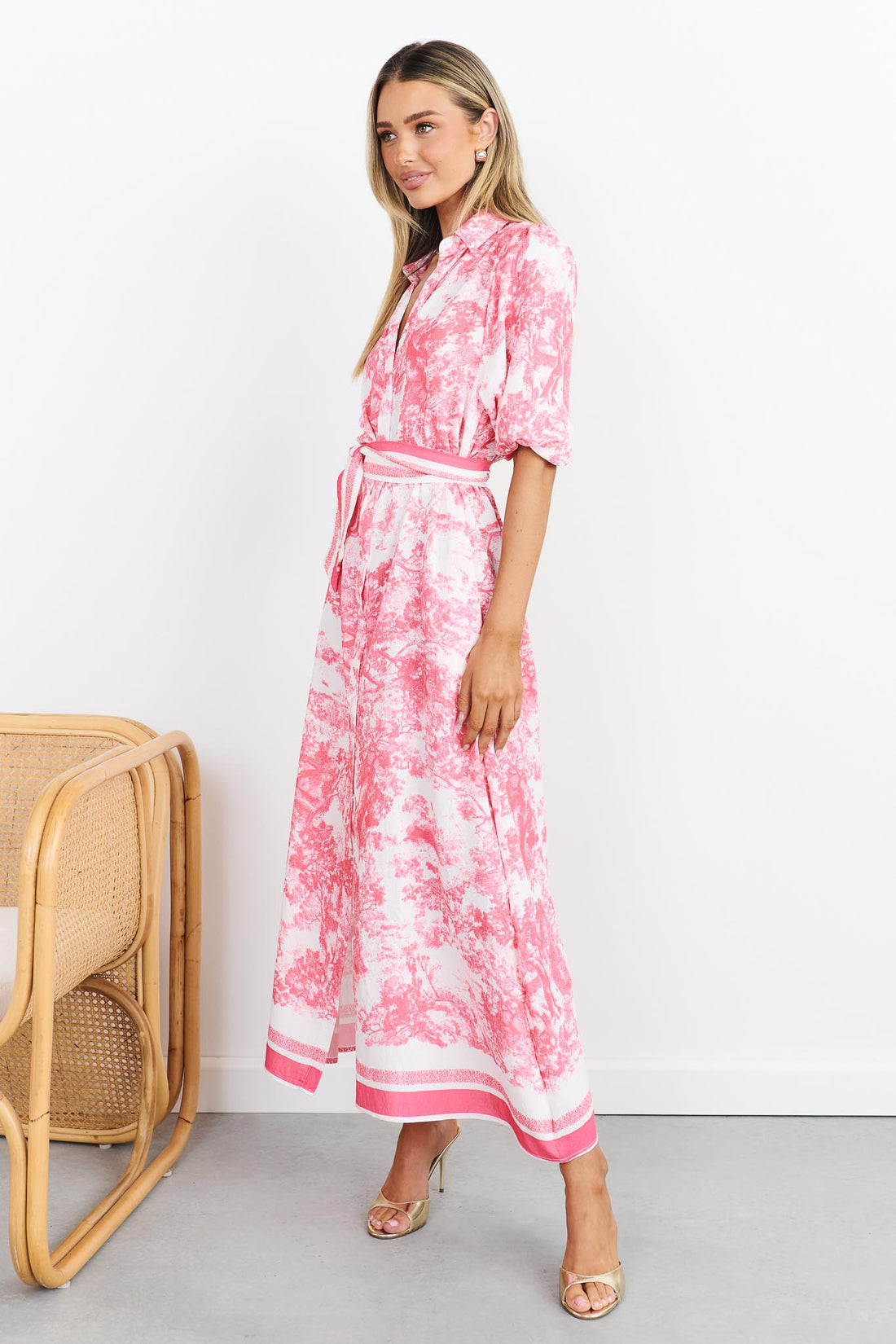 Side view of pink toile print shirt dress with a pink stripe waist tie