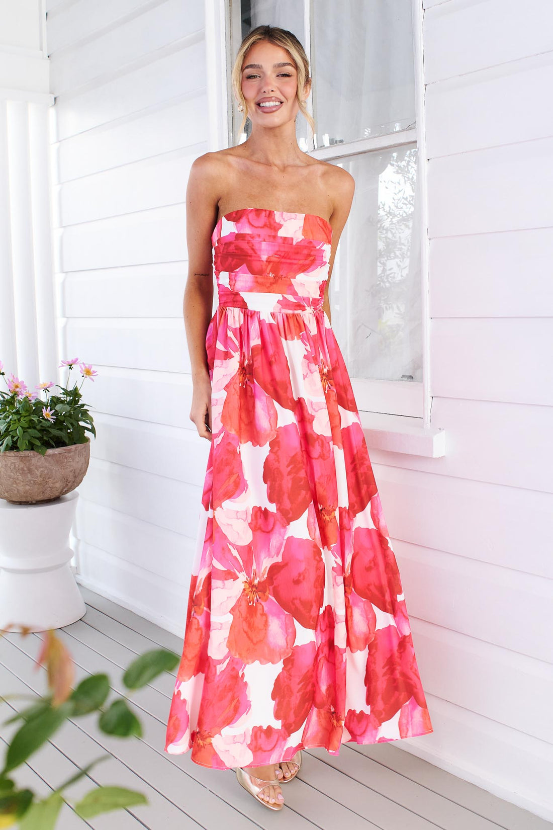 Woman wearing the minnie + MAXXIE Sienna Strapless pink floral event dress