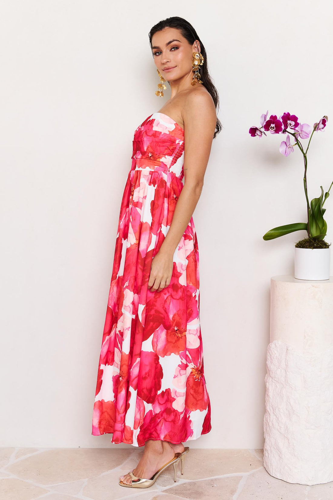 Side view of woman wearing the minnie + MAXXIE Sienna Strapless pink floral event dress