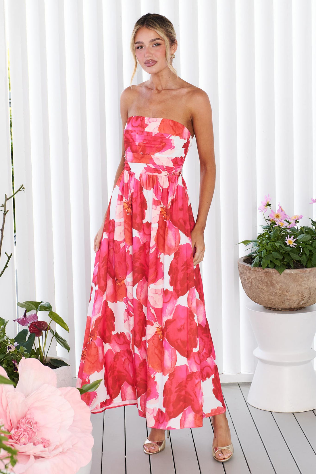 Woman wearing the minnie + MAXXIE Sienna Strapless pink floral event dress