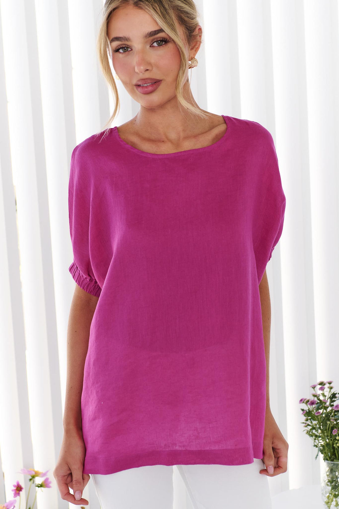 Woman wearing the minnie + MAXXIE studio linen top in Magenta pink