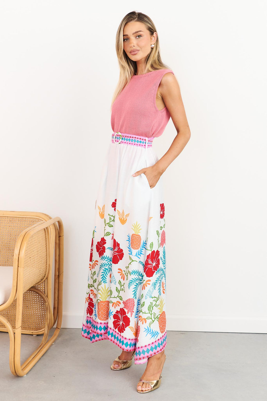 Side view of Valencia floral maxi skirt with pineapple print and pockets, styled with pink Villa knit tank